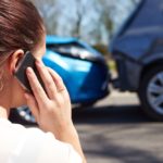 28154953 - female driver making phone call after traffic accident